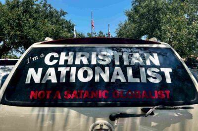 The back window of a car covered with a sticker that says