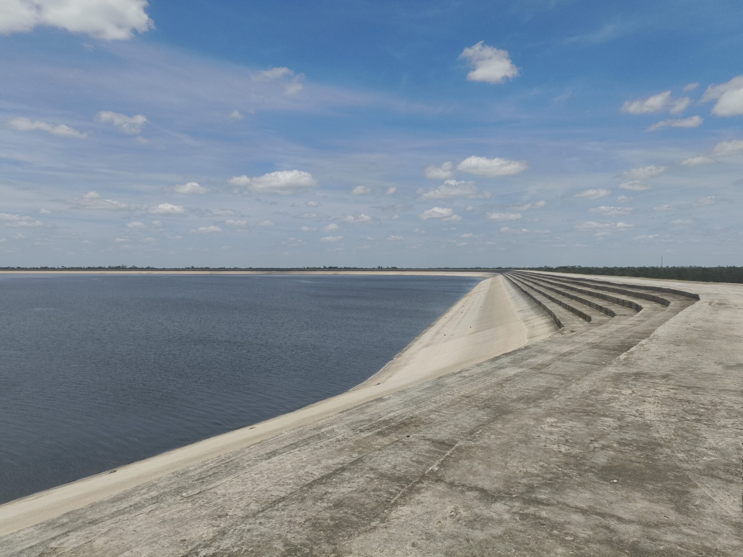 Concrete steps surround a large reservoir of water