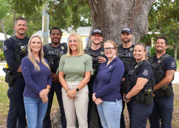 A group of people smile at the camera