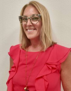 A woman smiles at the camera